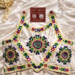 Navratri Gopika Gamthi blouse with colorful thread work, real mirror work and kodi latkan in heavy silk white sleeveless
